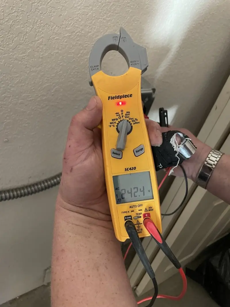 Voltage testing with clamp meter during Electrical Installation Services in Stafford